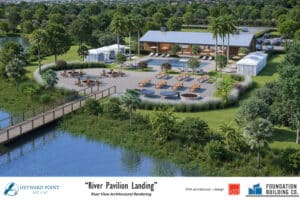 Aerial view of the Heyward Point River Pavilion with a pool, clubhouse, parking area, and surrounding palm trees.